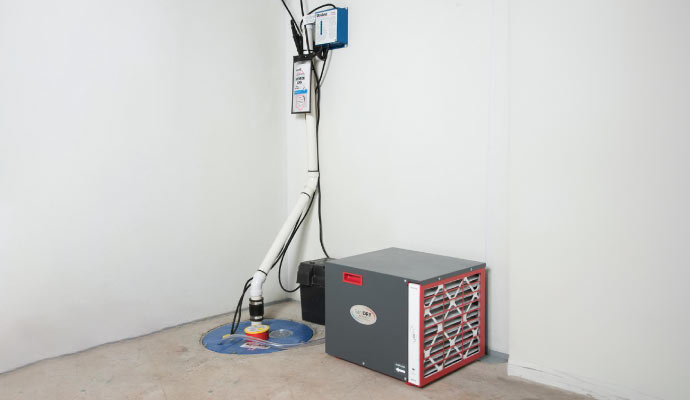 Basement corner with a sump pump system and dehumidifier