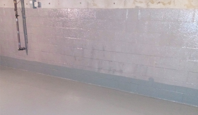 Moisture-sealed basement floor with waterproofing.