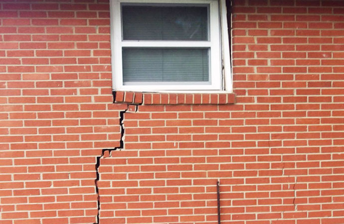 wall crack around a window, indicating potential maintenance needs.