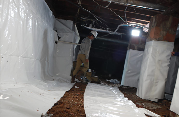 Worker working in the crawl space
