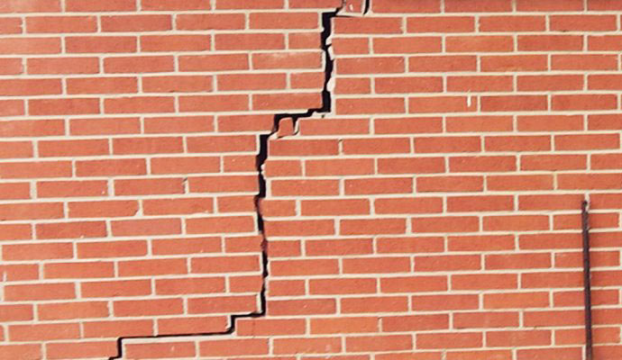 A brick wall with a large crack