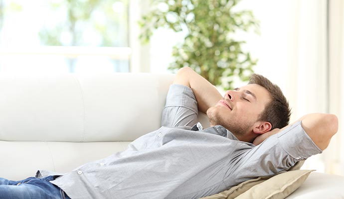 Man relaxing in living room Man relaxing in living room