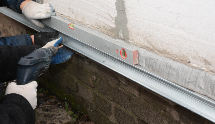 professional worker repairing foundation wall