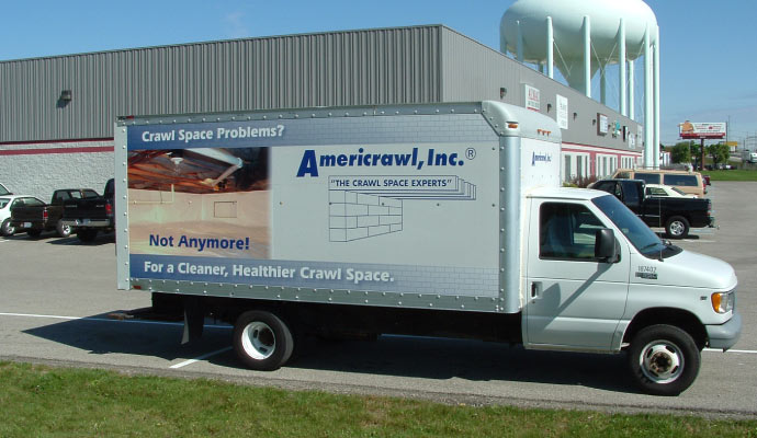 Americrawl service truck on road.