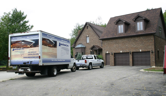 Americrawl service truck parket outside a house